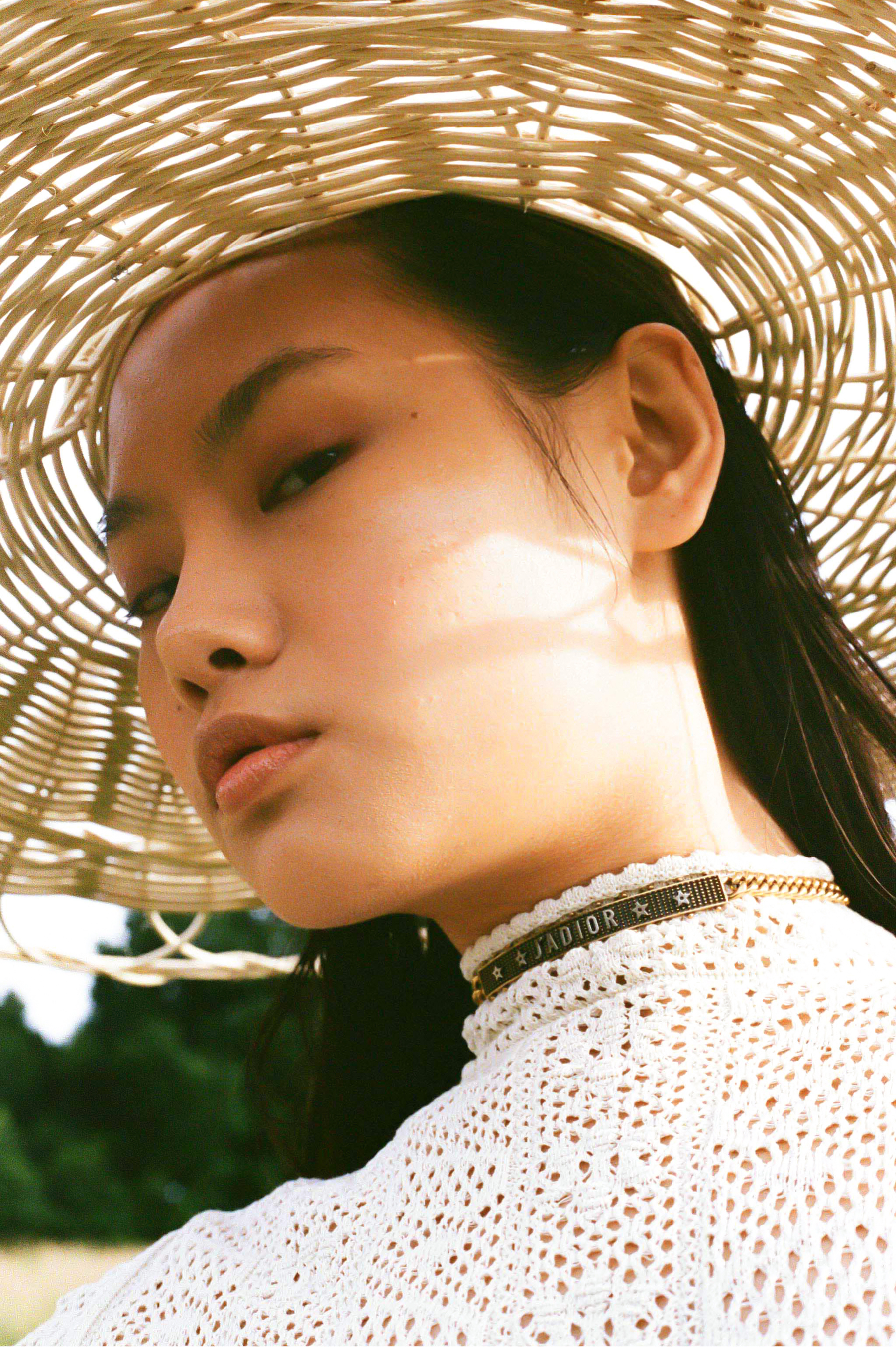 Model wearing a straw hat for fashion editorial
