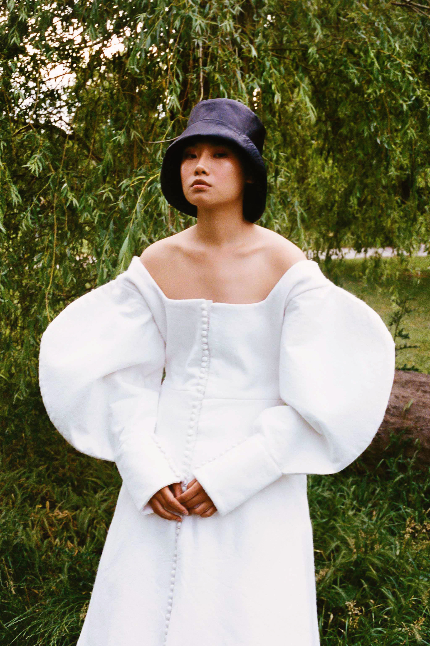 Model wearing a white puff sleeve dress for fashion editorial