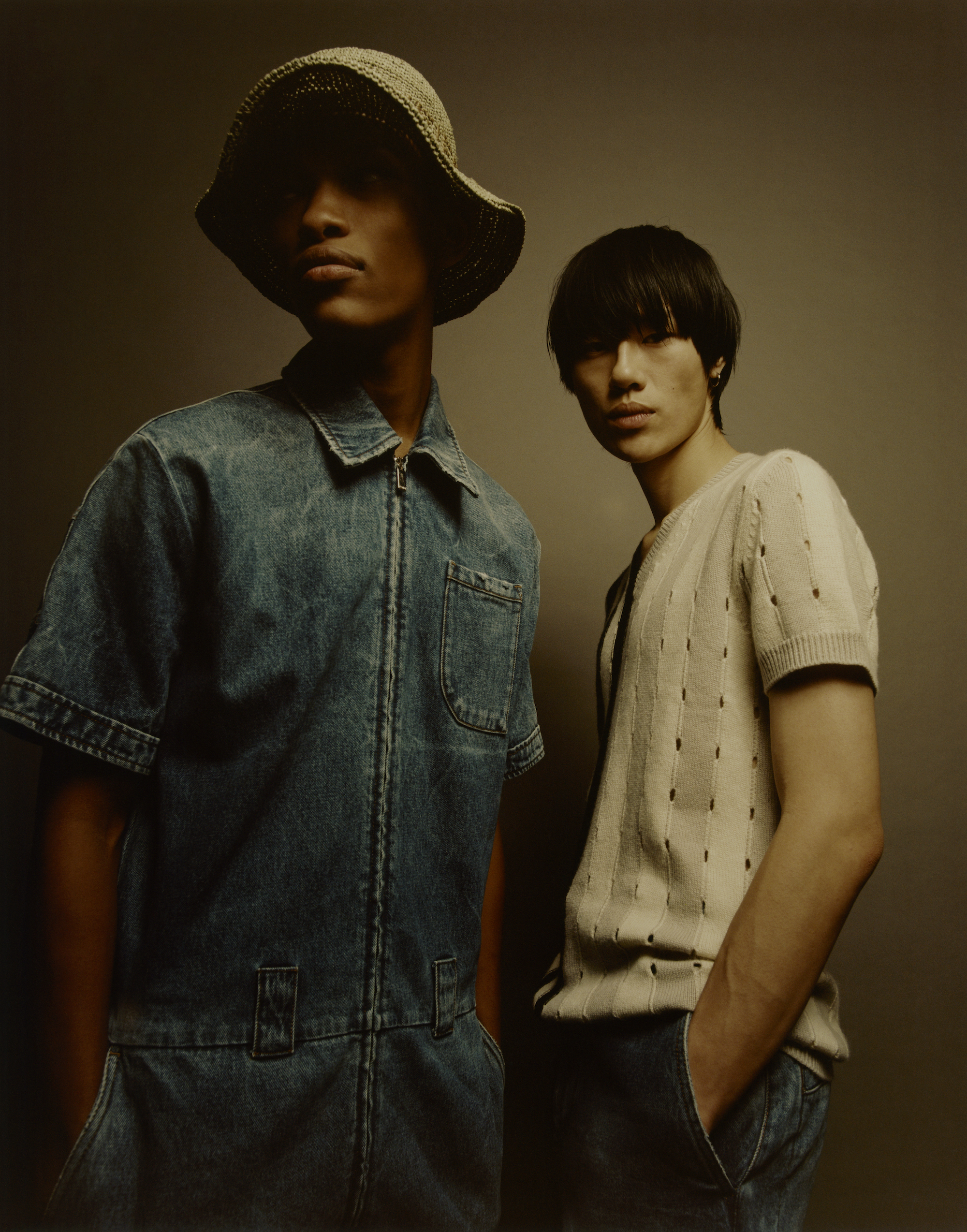 Fendi fashion editorial taken from our Spring issue model wears fendi print sunhat and demin shirt and the other wears Fendi jumper