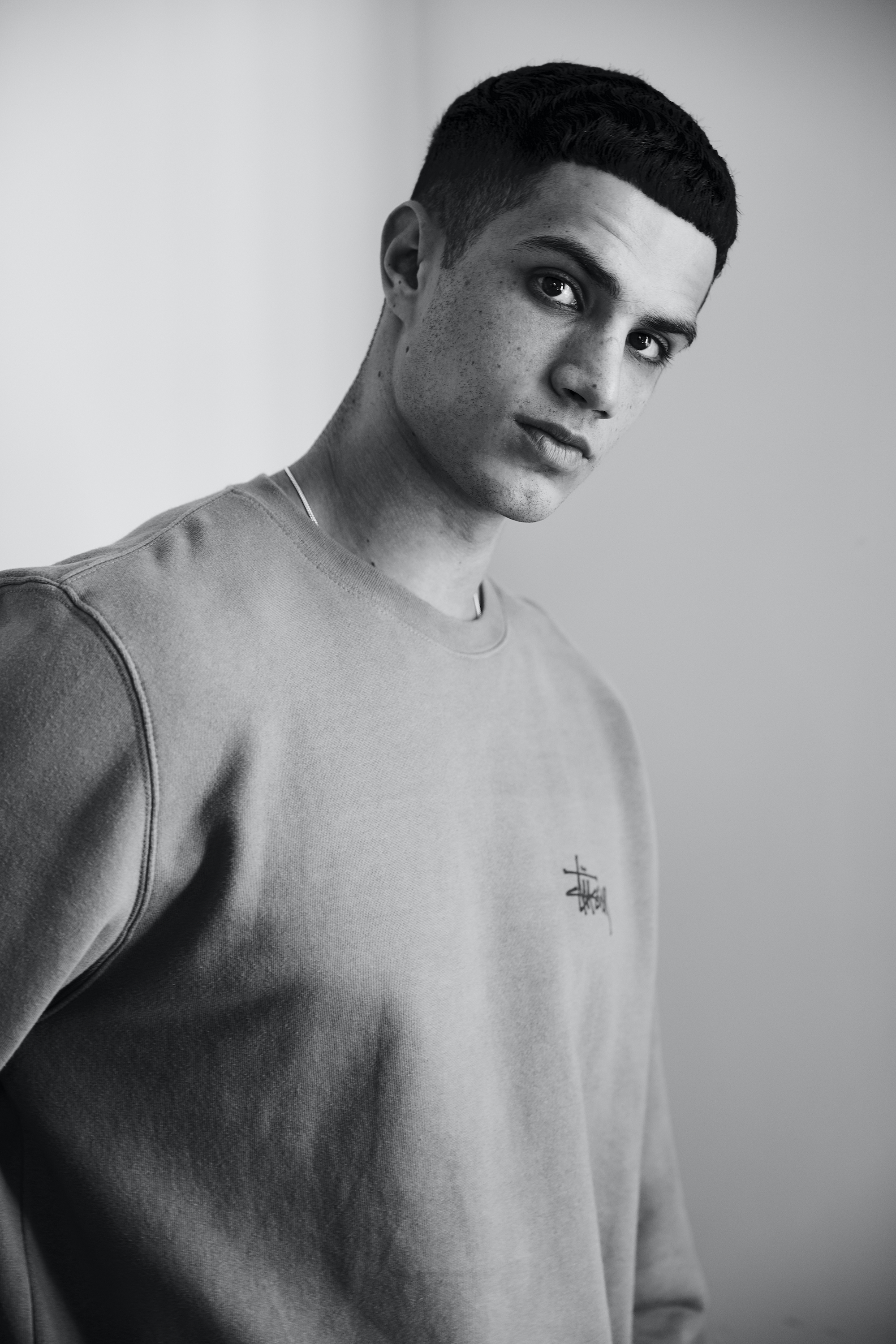 AUDIOCOMINGSOON Ashon wearing gray jumper in black and white t-shirt