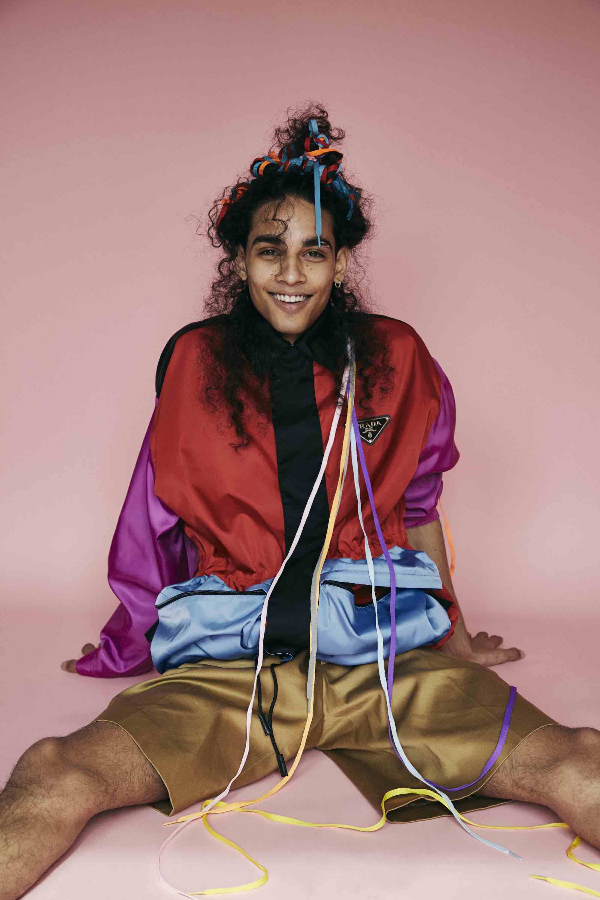 Model in multi-coloured jacket and shorts