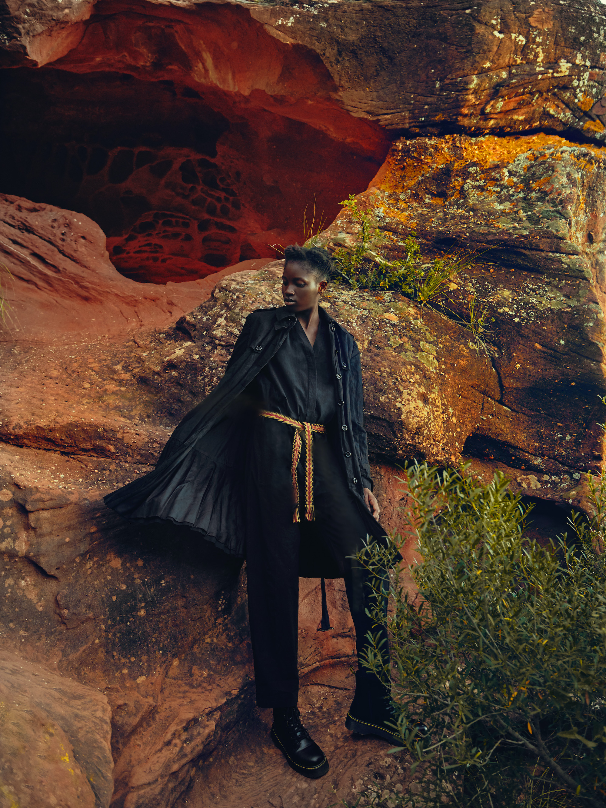 Model wearing black dress with yellow belt