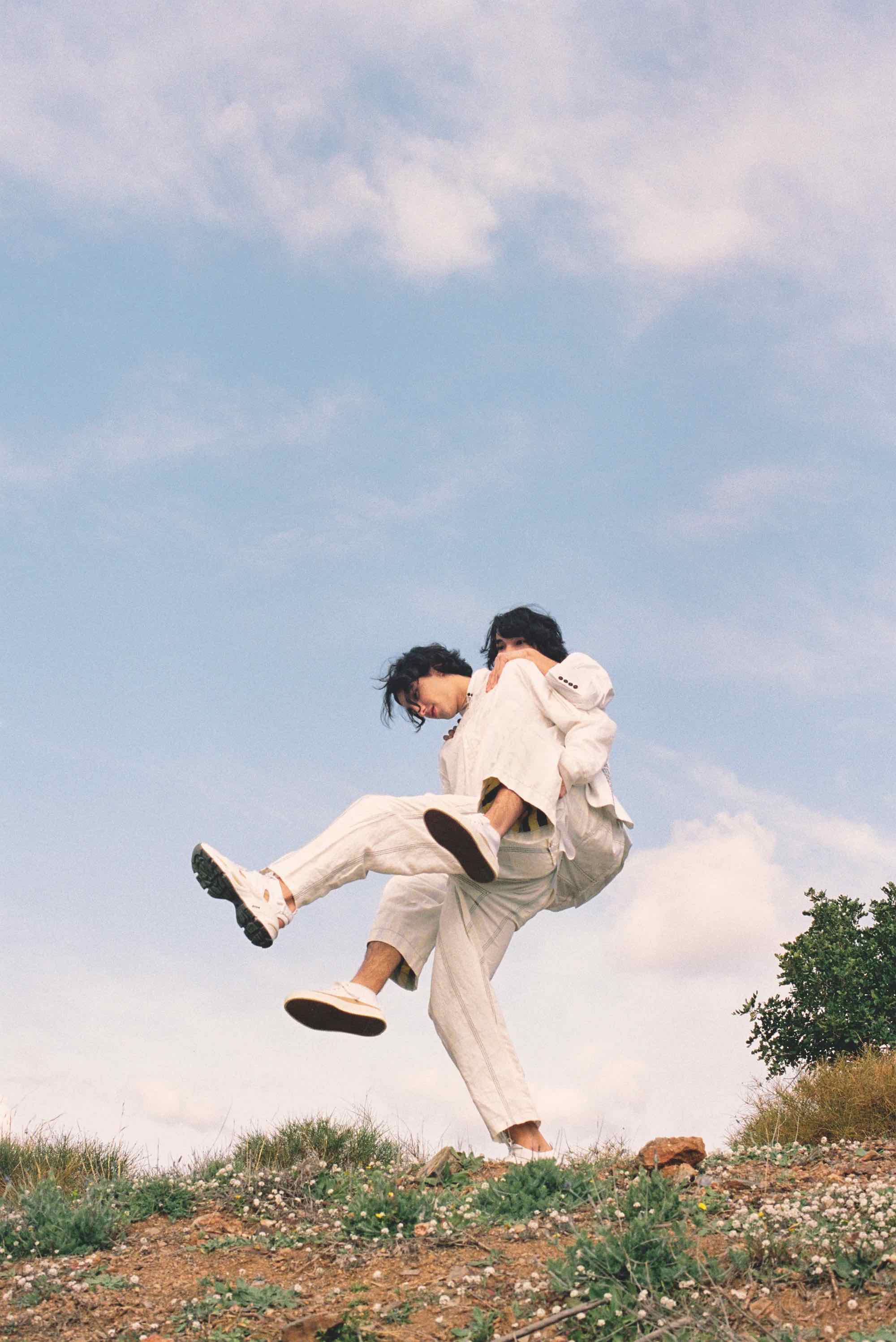 Fashion editorial shoot two boys carrying each other