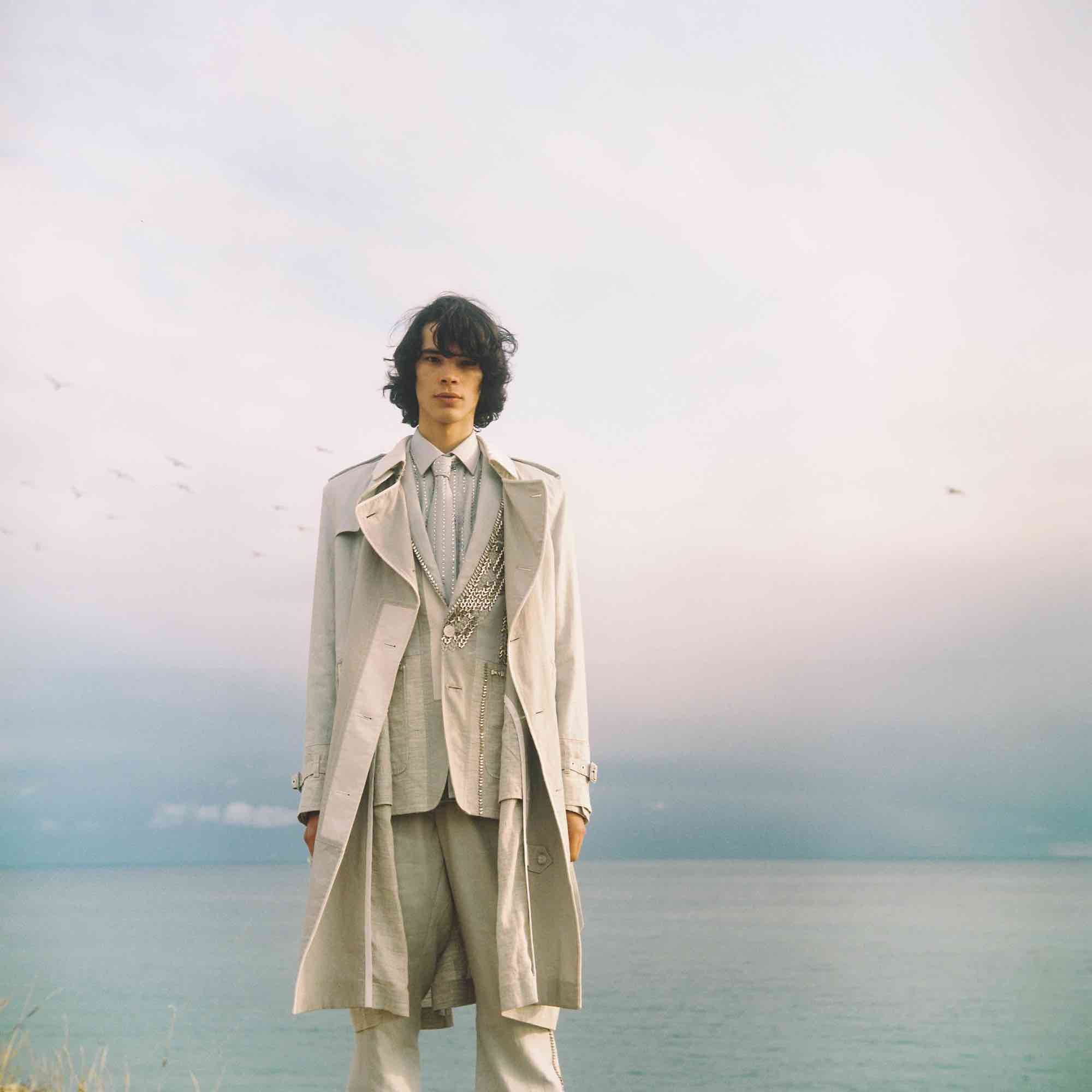 Fashion editFashion editorial man in a beige coatorial two boys grass