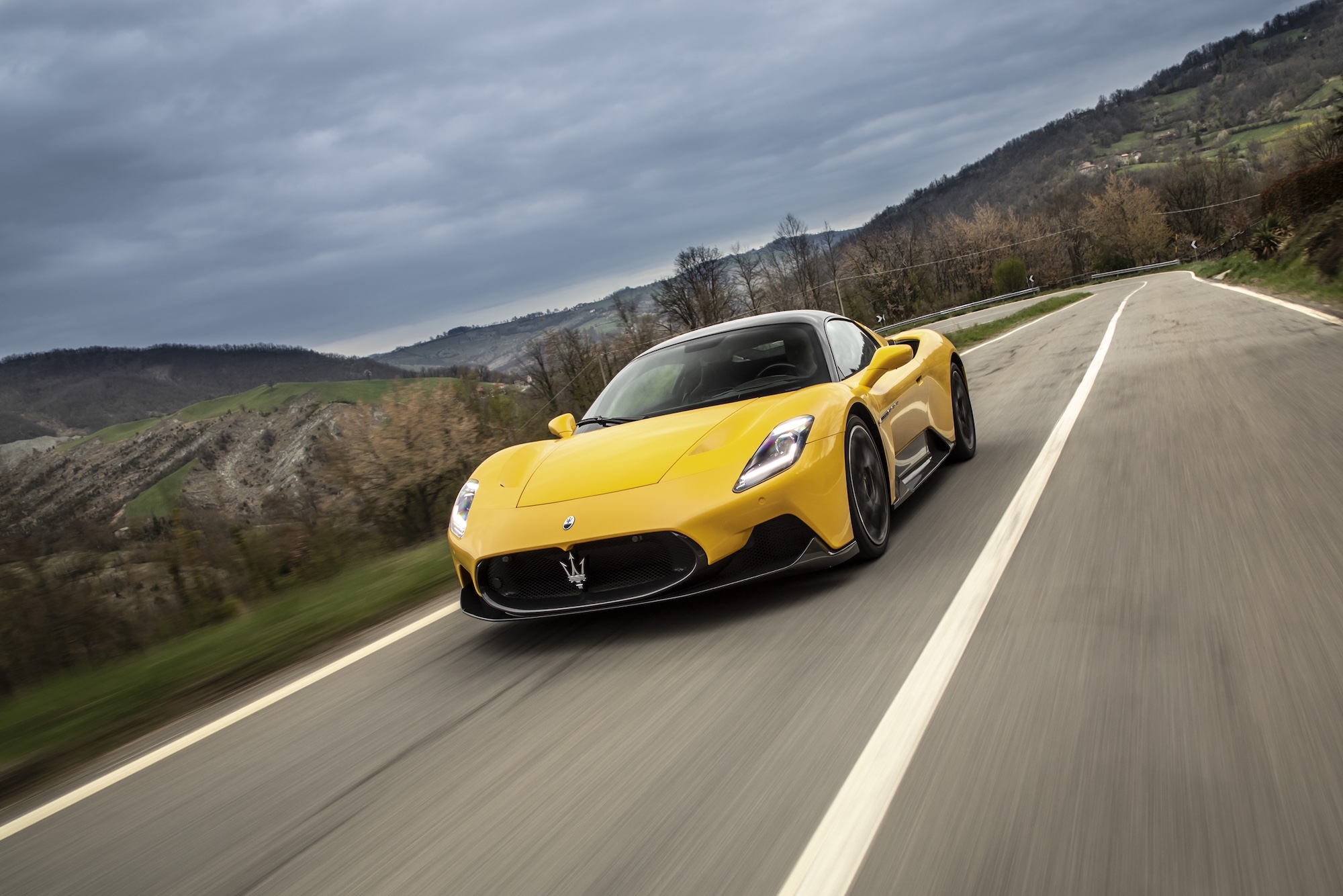 Maserati’s MC20 supercar driving past mountains